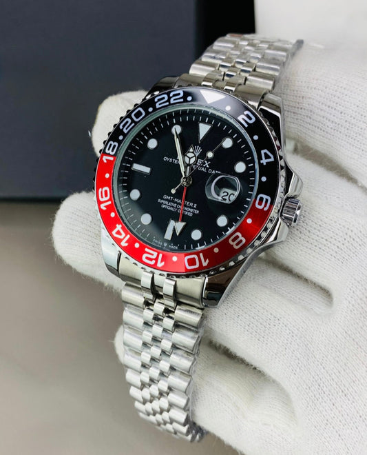 Rolex watch with black and red bezel on a white background